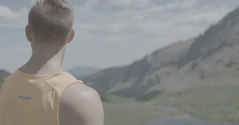 Hiker looking over lake Stock Footage 65149728