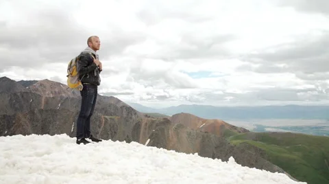 Hiker looking at view in high altitude mountain above the clouds Stock Footage 65483958
