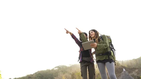 Hiker looking at the way through map on digital tablet Stock Footage 97678344