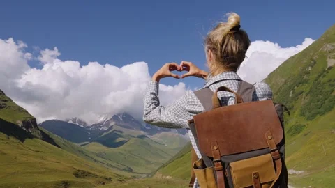Hiker making heart shape with hands in mountain valley Stock Footage 301402772