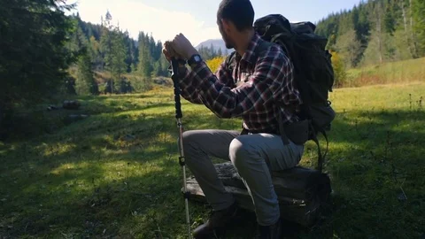 Hiker male with backpack in mountains Видео 82699162