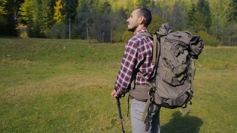 Hiker male with backpack in mountains Видео 82699356