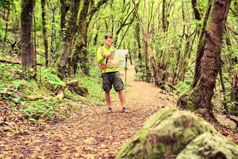 Hiker with map in forest Stock Photos