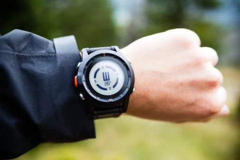 Hiker on mountain trail checking compass Stock Photos