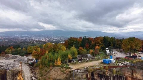 Hiker observes distant city from elevated vantage point in autumn Stock Photos