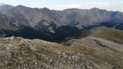 Hiker on peak, drone flyby Stock Footage 196199895