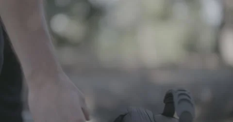 Hiker picking up bag by strap Stock Footage 65153084