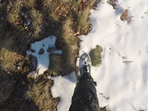 Hiker point of view walking on mountain on snowy path in sunny winter morning Stock Footage 83121373