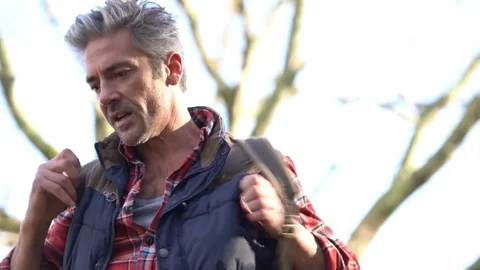 Hiker putting backpack up and reading map Stock Footage 72091735