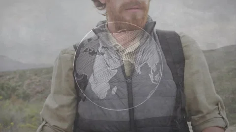 Hiker reading map on hillside map-led rotating globe overlay aiding travel while Stock Footage 330894413