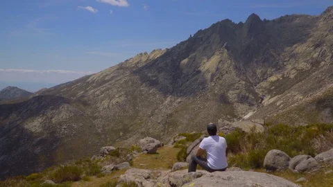 Hiker sees shadow passing clouds on mountainside Stock Footage 111266865