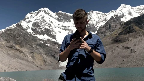 Hiker Sending A Text Message in the Peruvian Andes, Ausangate Видео 125280514