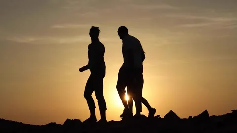Hiker silhouette with a backpack walking and following the trail uphill, enjoyin 動画素材 280107968