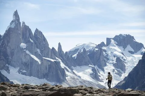 A hiker silhouetted against the massive peaks of Cerro Torre Stock Photos