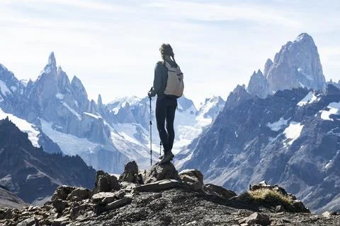 A hiker silhouetted against the massive peaks of Cerro Torre Stock Photos