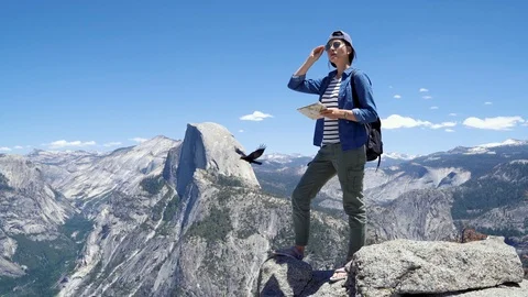 Hiker standing on mountain top with map Video stock 112121636