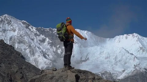 Hiker stands on top Stock Footage 84983993