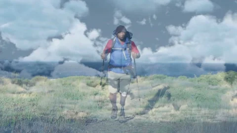 Hiker starting far walking toward cam with poles ocean overlay showing Video stock 332380776