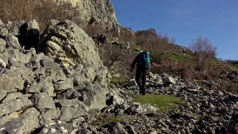 Hiker on the steep scree terrain to the summit of the mountain Stock-Footage 224063136