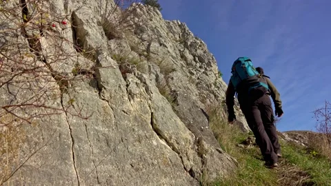 Hiker on the steep scree terrain to the summit of the mountain 스톡 동영상 224064777