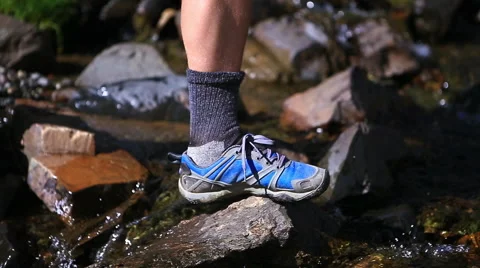 Hiker stepping crossing a stream Stock-Footage 50968127