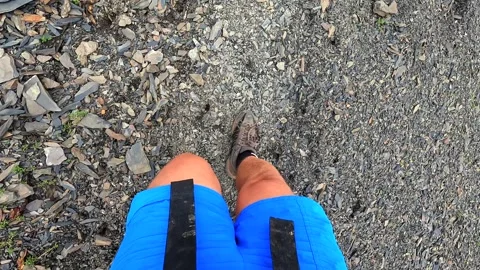 Hiker steps across loose scree on the Juta to Roshka route in Georgia Stock Footage 340385490