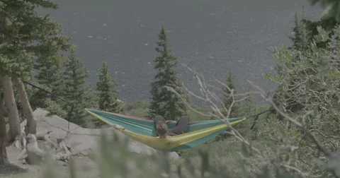Hiker swinging in hammock Stock Footage 65191987