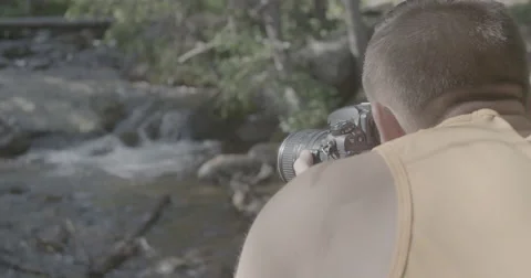 Hiker taking picture of stream Stock Footage 65170981