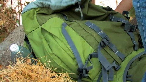 Hiker taking water bottle from back pack Stock Footage 89480702