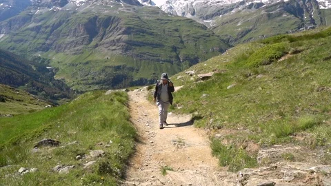 Hiker with tall mountains in background - Model Released - Slow Motion Stock Footage 93344541