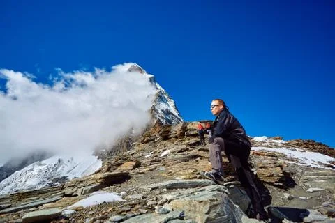 Hiker at the top of a pass Stock Photos