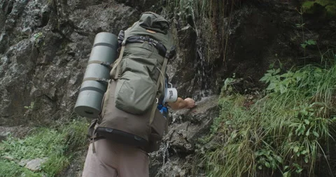 A Hiker Is Touching A Fresh Stream To Cool Down Stock Footage 228963106