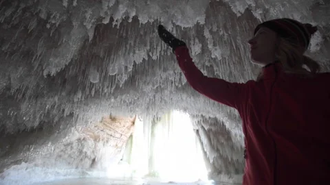A hiker touching ice formations Stock Footage 144782861