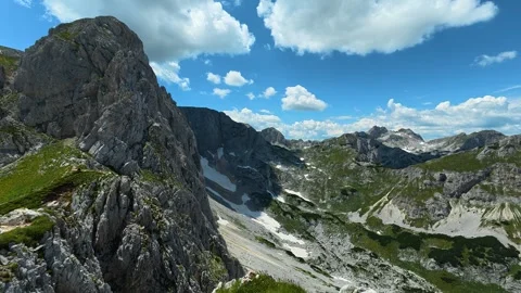 Hiker traverses rugged mountain trail with care. Savin Kuk peak, Montenegro Stockbeeldmateriaal 342979109