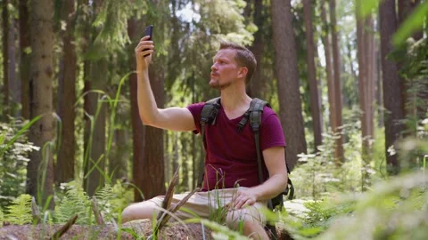 Hiker trying to boost cell phone signal Stock Footage 134297638