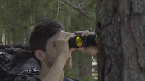 Hiker using binoculars to watch birds in woods Stock Footage 75199428