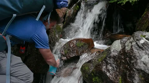 Hiker using a Filtered Water Bottle Stock Footage 157076505
