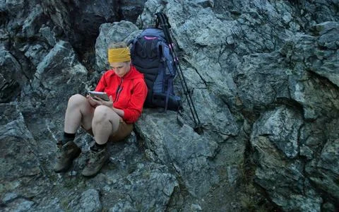 Hiker using portable tablet technology Stock Photos