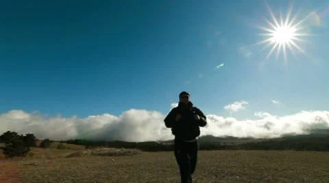 Hiker walking along a mountain plateau Stock Footage
