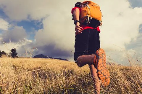 Hiker walking with backpack Stock Photos