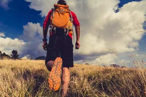 Hiker walking with backpack Stock Photos