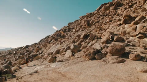 Hiker Walking in Desert Toward Camera (Jib Shot) Stock Footage 49109512