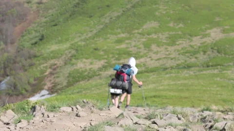 Hiker walking down from the the top Stock Footage 89523178