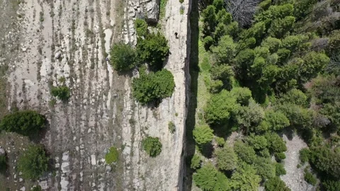 Hiker walking on earth crack with cloud shadows 4K Stock Footage 143933830