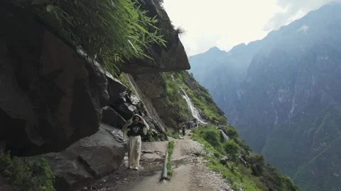 Hiker Walking On High Trail Of Tiger Leaping Gorge In Yunnan China Stock Footage 335343891