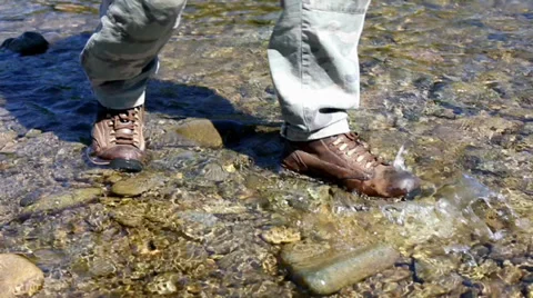 Hiker walking of a mountain river. Video stock 27818622
