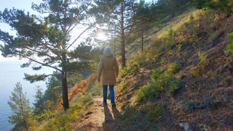 The hiker walking in the mountain on the sunset background. Slow motion Stock Footage 123974378