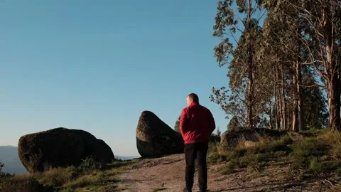 Hiker walking on mountain trail at sunset Stock Footage 344531149