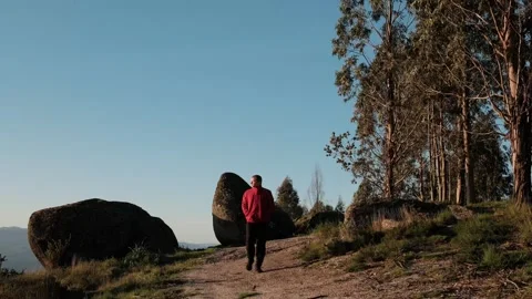Hiker walking on a mountain trail at sunset Stock Footage 344531152