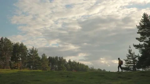 A hiker walking in nature carrying backpack. Stock Footage 220188853